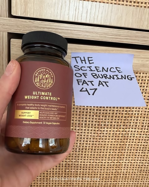 A close-up shot showing a hand holding a bottle of weight control capsules next to a handwritten sticky note.
